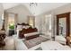 Luxurious main bedroom with elegant decor, hardwood floors, and ample natural light, creating a serene retreat at 131 Forsyth Park Ln, Woodstock, GA 30188