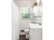 Cozy bathroom with white tiling, and a large window overlooking the exterior at 1744 Blossom Ln, Austell, GA 30168