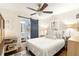 Bright bedroom with white walls, hardwood floors, ceiling fan and an ensuite bathroom with sliding barn door at 1744 Blossom Ln, Austell, GA 30168