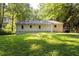 Back exterior view of the house, showing the well-maintained lawn and siding at 1744 Blossom Ln, Austell, GA 30168