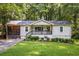 Charming single-story home features a screened porch and well-manicured lawn and landscape at 1744 Blossom Ln, Austell, GA 30168