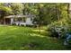 Charming front yard with lush landscaping and blue hydrangeas, adding curb appeal to the home at 1744 Blossom Ln, Austell, GA 30168
