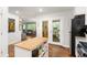 Modern kitchen with island and stainless appliances open to the living area with an outdoor view at 1744 Blossom Ln, Austell, GA 30168