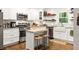 Bright, modern kitchen with white cabinetry, stainless steel appliances, and a butcher block island at 1744 Blossom Ln, Austell, GA 30168
