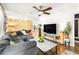 Bright, open-concept living area with modern decor, hardwood floors, and a cozy sectional sofa at 1744 Blossom Ln, Austell, GA 30168