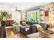 Comfortable living space featuring hardwood floors, gray sectional sofa, and lots of natural light at 1744 Blossom Ln, Austell, GA 30168