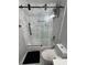 Modern bathroom featuring marble tile and a sleek glass shower door at 2535 Village Creek Lndg, Atlanta, GA 30316
