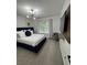 Bedroom featuring a dark blue headboard and wall-mounted TV at 2535 Village Creek Lndg, Atlanta, GA 30316
