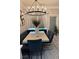 Bright dining room features a modern chandelier, seating bench, and sleek table with stylish chairs at 2535 Village Creek Lndg, Atlanta, GA 30316