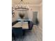 Bright dining room features a modern chandelier, seating bench, and sleek table with stylish chairs at 2535 Village Creek Lndg, Atlanta, GA 30316