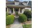 Charming home with a covered front porch, manicured landscaping, and a welcoming green front door at 2535 Village Creek Lndg, Atlanta, GA 30316