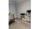 Stylish hallway featuring geometric wallpaper, glass table, and neutral carpeting at 2535 Village Creek Lndg, Atlanta, GA 30316