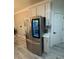 Stainless steel LG refrigerator with a glass door and built-in shelving within a white kitchen at 2535 Village Creek Lndg, Atlanta, GA 30316