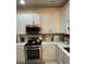 Bright kitchen featuring white cabinets, stainless steel appliances, and sleek countertops at 2535 Village Creek Lndg, Atlanta, GA 30316