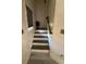 Well-lit stairway with dark wood treads and white risers leading to the upper level at 2535 Village Creek Lndg, Atlanta, GA 30316
