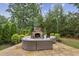 Comfortable backyard with stone fireplace and cushioned seating at 2579 Lulworth Ln, Marietta, GA 30062