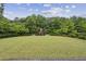 Expansive backyard with lush lawn and a brick fire pit area perfect for outdoor entertaining at 2579 Lulworth Ln, Marietta, GA 30062