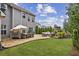 Beautiful backyard with stone patio, outdoor fireplace, dining area and string lights at 2579 Lulworth Ln, Marietta, GA 30062