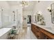 Spa-like primary bathroom with a glass-enclosed shower, soaking tub, and double vanity sinks at 2579 Lulworth Ln, Marietta, GA 30062