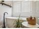 Relaxing bathroom featuring a freestanding tub, white shutters, and stylish accents at 2579 Lulworth Ln, Marietta, GA 30062
