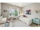 Bright bedroom features a patterned rug, large window, and playful decorations at 2579 Lulworth Ln, Marietta, GA 30062