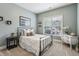 Cozy bedroom showcasing a comfortable bed, decorative shelves, and a bright window at 2579 Lulworth Ln, Marietta, GA 30062
