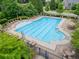 Large community pool surrounded by lounge chairs and tables, perfect for relaxing and socializing at 2579 Lulworth Ln, Marietta, GA 30062