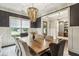 Formal dining room with large window, elegant chandelier, and seating for ten at 2579 Lulworth Ln, Marietta, GA 30062