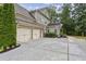 Spacious three-car garage with extended driveway and basketball hoop at 2579 Lulworth Ln, Marietta, GA 30062