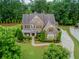 Beautiful home featuring a manicured lawn, mature landscaping, and a paved driveway with basketball hoop at 2579 Lulworth Ln, Marietta, GA 30062