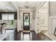 Welcoming foyer with dark hardwood flooring, elegant chandelier, and paneled walls at 2579 Lulworth Ln, Marietta, GA 30062