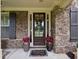 Charming entrance features a brick and stone facade, decorative wreath, and welcome mat at 2579 Lulworth Ln, Marietta, GA 30062
