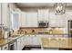 Well-equipped kitchen with white cabinetry, granite countertops, and stainless steel appliances at 2579 Lulworth Ln, Marietta, GA 30062