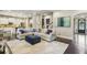 Open-concept living room featuring a comfortable sectional sofa, stylish decor, and hardwood floors at 2579 Lulworth Ln, Marietta, GA 30062