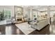 Open-concept living room with hardwood floors, a cozy fireplace, and an abundance of natural light at 2579 Lulworth Ln, Marietta, GA 30062
