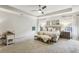 Spacious primary bedroom with a tray ceiling, plush carpet, and a sitting area at 2579 Lulworth Ln, Marietta, GA 30062