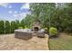 Outdoor patio with a stone fireplace, comfortable seating, and lush greenery at 2579 Lulworth Ln, Marietta, GA 30062