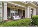 Charming porch with a swing, columns, and lush landscaping offering a relaxing outdoor space at 2579 Lulworth Ln, Marietta, GA 30062
