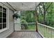 Back deck features wooden floorboards, a white railing and view of the private wooded lot at 2816 Highland Park Dr, Stone Mountain, GA 30087