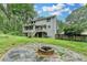 Back of house showing the deck, walkout basement, and stone fire pit at 2816 Highland Park Dr, Stone Mountain, GA 30087