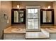 Bright bathroom featuring dual sinks, large mirrors and a window at 2816 Highland Park Dr, Stone Mountain, GA 30087