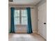 Bright bedroom with carpet and a window with teal curtains at 2816 Highland Park Dr, Stone Mountain, GA 30087