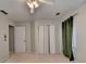 Neutral bedroom features a ceiling fan, closet, doors and neutral carpet at 2816 Highland Park Dr, Stone Mountain, GA 30087