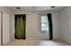 Neutral bedroom features a closet, a window with curtains, and neutral carpet at 2816 Highland Park Dr, Stone Mountain, GA 30087