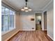 Dining area with hardwood floors, a stylish light fixture, and a large picture window at 2816 Highland Park Dr, Stone Mountain, GA 30087
