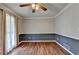Empty dining room with hardwood floors, chair railing, and natural light from a window with curtains at 2816 Highland Park Dr, Stone Mountain, GA 30087