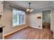 Light-filled dining room with wood floors, view to backyard, and decorative light fixture at 2816 Highland Park Dr, Stone Mountain, GA 30087