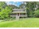 Charming two-story home with a welcoming front porch and a well-manicured lawn with mature landscaping at 2816 Highland Park Dr, Stone Mountain, GA 30087