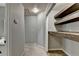 Hallway with access to walk-in closet featuring custom wood shelving at 2816 Highland Park Dr, Stone Mountain, GA 30087