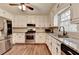 Well-lit kitchen features stainless steel appliances and white cabinetry and granite countertops at 2816 Highland Park Dr, Stone Mountain, GA 30087